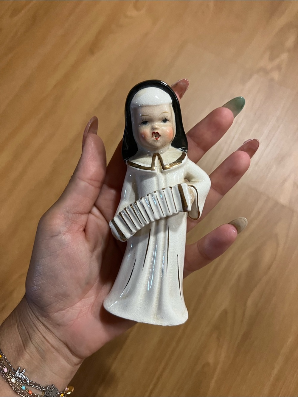 Japanese ceramic/porcelain nun figurine playing an accordion